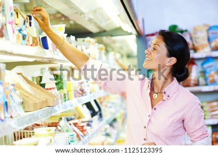 shopping in supermarket. Woman choosing foodproducts