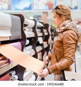 Shopping Time: Beautiful Blond Young Woman Having Fun In The DIY Supermarket Department Store Choosing For Buying Wallpaper Holding & Looking At Design Image