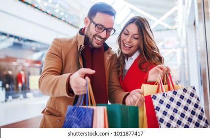 Shopping Time. Beautiful Young Couple Enjoying In Shopping, Having Fun Together In Shopping Mall. Consumerism, Love, Dating, Lifestyle Concept