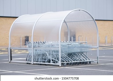 Shopping Trolley Group In Shelter At Supermarket Shop Car Park