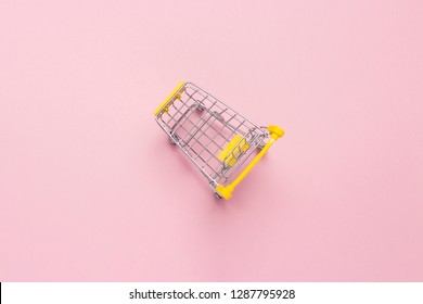 Shopping Trolley From The Supermarket On An Isolated Pink Background. Shopping In The Mall, Shop, Shopping. Flat Lay, Top View.