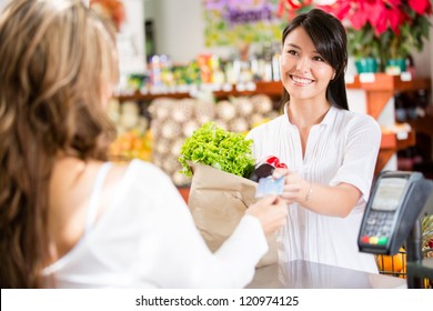 Shopping Woman At The Checkout Paying By Card