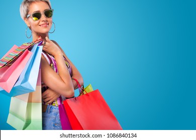 Shopping Woman Holding Color Bags Isolated On Blue Background In Black Friday Holiday. Summer Shopping Sale Concept.