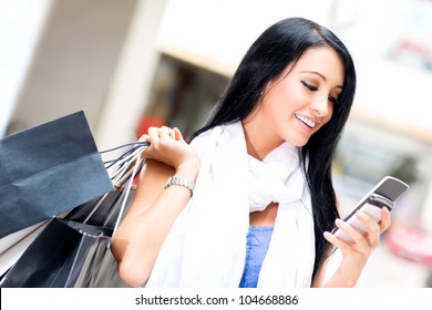 Shopping Woman Sending A Text Message On Her Cell Phone