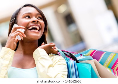 Shopping woman talking on the phone at a mall
