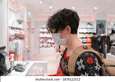 Shopping Woman Wearing Medical Mask Short Hair. Waiting At Cash Register To Pay. For Christmas Or New Year. Ugly Christmas Sweater And Backpack . Coronavirus Times Pandemic. Blurry Photo. 2021