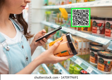 Shopping. Young Woman Scans Qrcode Of The Body Cream. Modern Technology In Everyday Life. Close Up