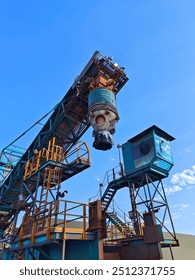 A shore loader or sprout with blue sky background in the port area.