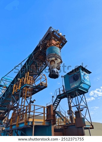 A shore loader or sprout with blue sky background in the port area.