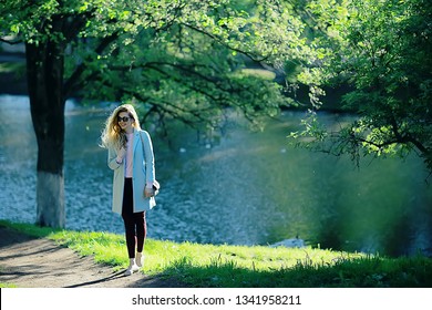 shore pond park adult girl / walk in city park, beautiful girl near pond in urban outdoor recreation area