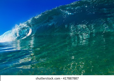 Shorebreak Surfing Tube Wave. Pipeline In Daylight With Light Of Sun. Green Blue Ocean Water. Surfing Template Design With Nobody. White Splashes And Ocean Foam. Sky With No Clouds. Surfing Rip Curl.