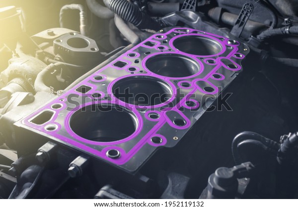 Short block with installed cylinder head gasket.\
Repair of a turbocharged diesel engine in a car workshop. Close up.\
Blur effect.