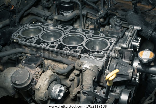 Short block\
with installed cylinder head gasket. Repair of a turbocharged\
diesel engine in a car workshop. Blur\
effect.