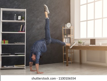 Short Break For Yoga In Office. Flexible Man Practicing Yoga At Workplace, Making Stretching Exercise While Using Tablet, Copy Space. Active Employee At Work, Healthy Lifestyle Concept