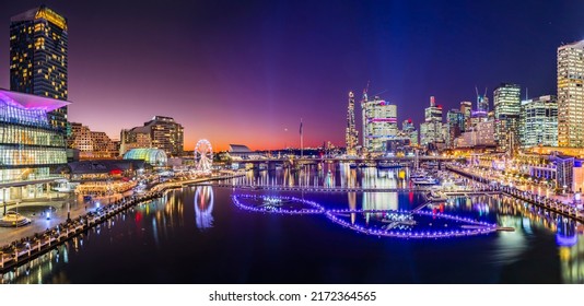 Short bright sunset panorama of Darling harbour Cockle bay in Sydney city CBD at Vivid Sydney light festival show. - Shutterstock ID 2172364565