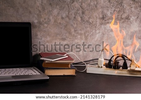 Short circuit An electrical outlet or electronic device bursts into flames while charging a mobile phone battery. and computer Using a substandard plug or cord