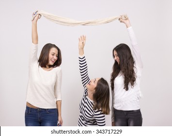short girl trying to reach taller girls scarf