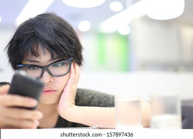 Short Hair Girl Looking Mobile Phone And Feeling Unhappy