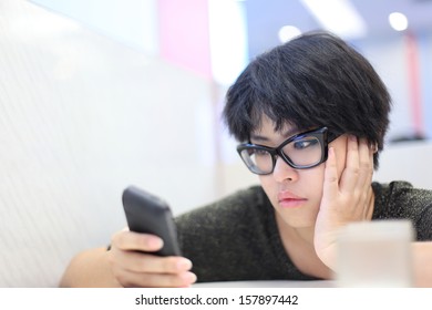 Short Hair Girl Looking Mobile Phone And Feeling Unhappy