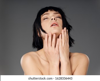 Short haircut woman tilted her head back bare shoulders