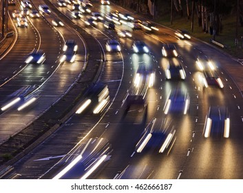 Short Headlamps Of Incoming Torrent Of Cars On Multi Lane Warringah Freeway Going Across The City Of Sydney, Australia. 