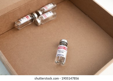 Shortages Of Covid-19 Vaccine. Vial With Coronavirus Sars-Cov-2 Jab Injections. Delay Of Vaccine Setback For Its Immunization Race. Close Up Ampoules Dose On Blue Background And Place For Text. 