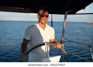 Short-haired confident mature man sailing on a yacht