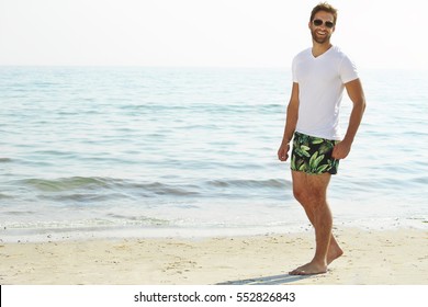 Shorts Guy On Beach Smiling At Camera