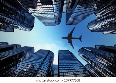 Shot of airplane flying above glass office buildings. Fisheye lens effect. - Powered by Shutterstock