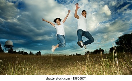 A shot of an asian couple jumping for joy