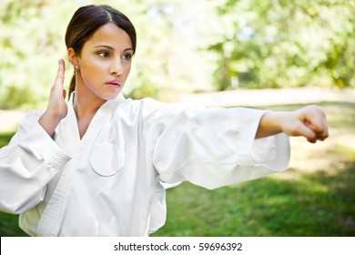 A Shot Of An Asian Woman Practicing Karate