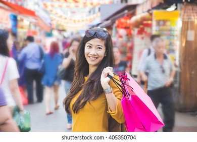 A Shot Of An Asian Woman Shopping Outdoor