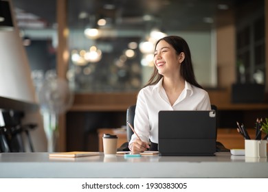 Shot Of A Asian Young Business Female Working On Laptop In Her Workstation.