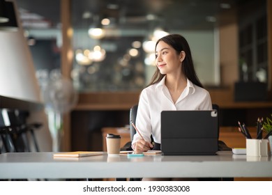 Shot Of A Asian Young Business Female Working On Laptop In Her Workstation.