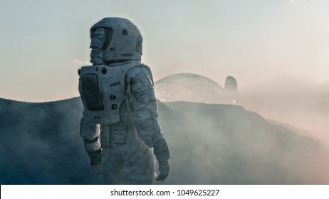 Shot of the Astronaut on Red Planet Watching Toward His Base/Research Station. Near Future First Manned Mission To Mars, Technological Advance Brings Space Exploration, Colonization.