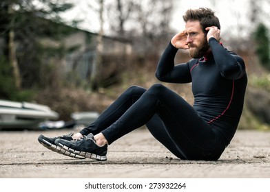 A shot of an athlete doing sit-ups outside - Powered by Shutterstock