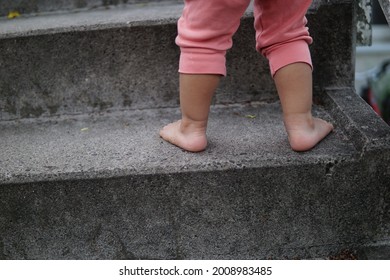 A Shot Of Baby Feet Climbing Stairs