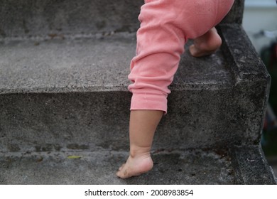 A Shot Of Baby Feet Climbing Stairs