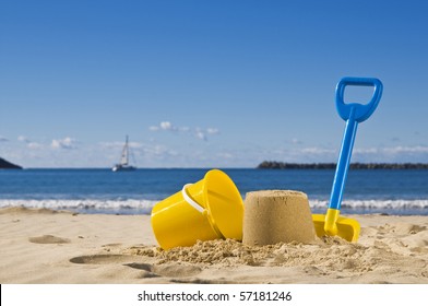 Shot Of The Beach With A Spade And Bucket In Foreground.