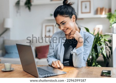 Shot of beautiful attractive entrepreneur woman working with laptop while drinking coffee in the living room at home.