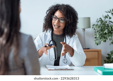 Shot of beautiful cheerful female doctor talking while explaining medical treatment to patient in the consultation. - Powered by Shutterstock