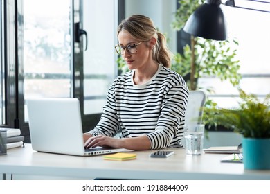 Shot Of Beautiful Mature Business Woman Working While Typing With A Laptop On A Desk In The Office At Home.