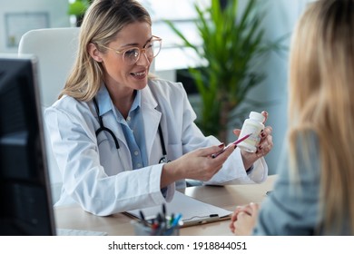 Shot Of Beautiful Mature Female Doctor Talking While Explaining Medical Treatment While Prescribing Medication To Patient In The Consultation.