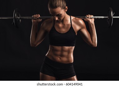 Shot Of A Beautiful Young Woman In A Workout Gear Lifting Weights