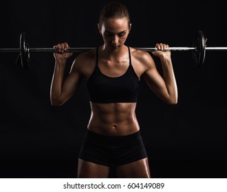 Shot Of A Beautiful Young Woman In A Workout Gear Lifting Weights