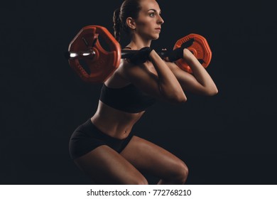 Shot Of A Beautiful Young Woman In A Workout Gear Lifting Weights