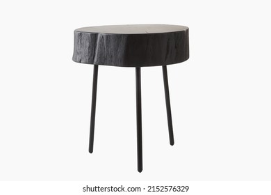 A shot of black three legged stool made of wood trunk and steel isolated on a white background