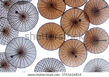 A shot from the bottom angle of batik patterned umbrellas in the afternoon in Surakarta, Indonesia.