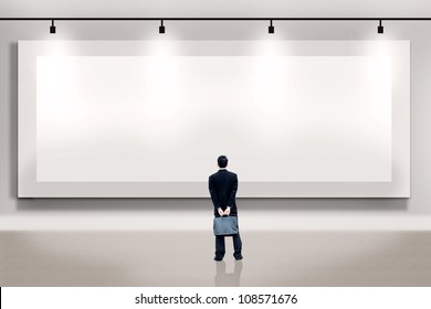 Shot of businessman looking at large empty billboard. Copy space available  for your own work