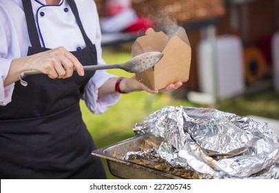 A shot of a Caterer serving takeaway food